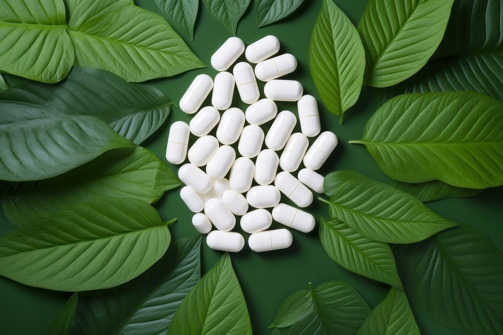 White pills on green leaf plant antioxidant medication. AI generated Image by rawpixel.