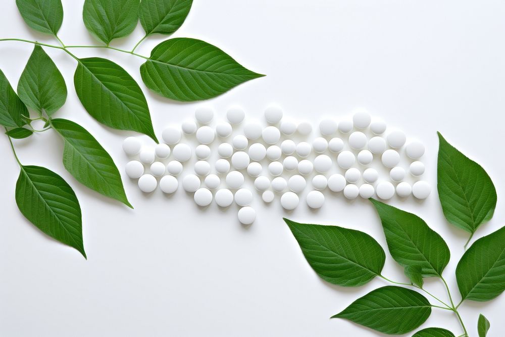 White pills on green leaf plant medication freshness. AI generated Image by rawpixel.