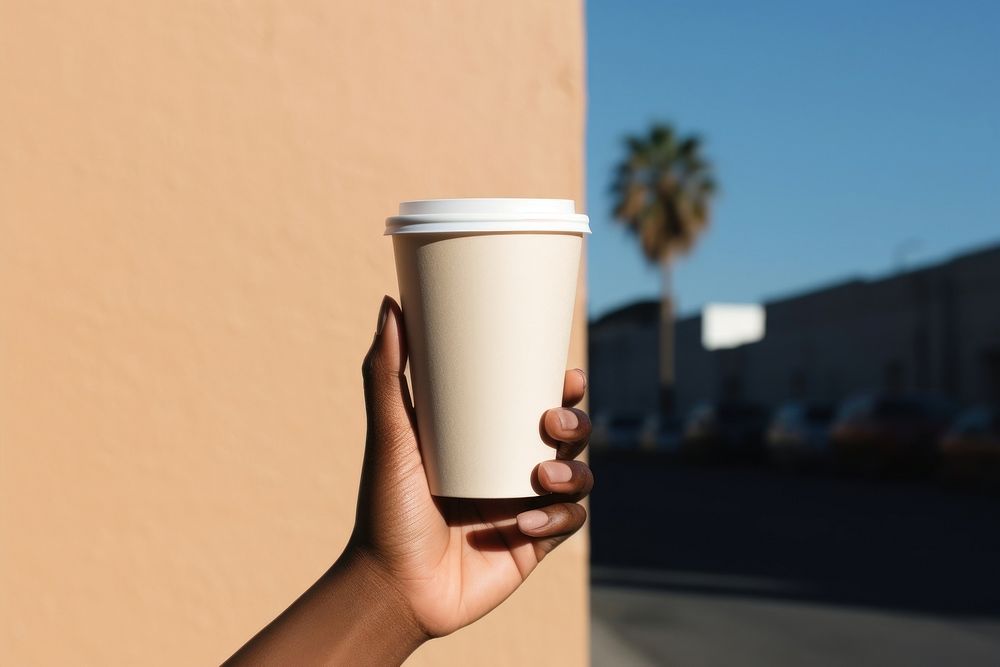 Brown skin person hand holding white paper coffee cup mug refreshment disposable. AI generated Image by rawpixel.