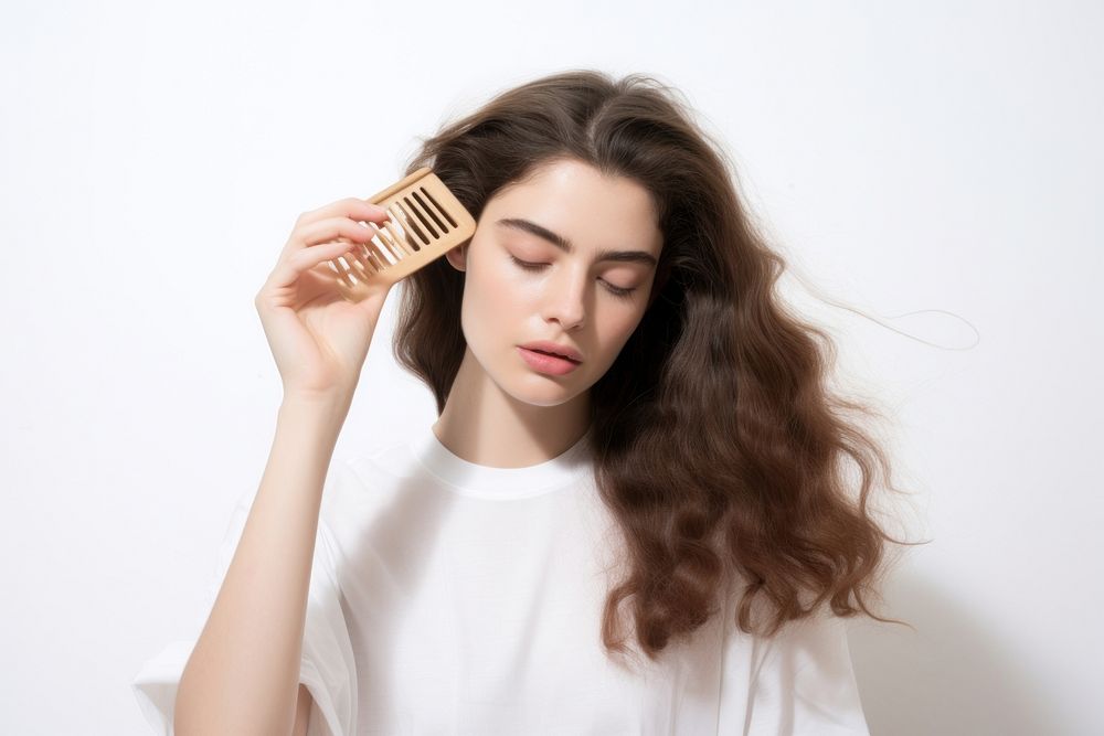 The woman is brushing her hair adult white background contemplation. AI generated Image by rawpixel.