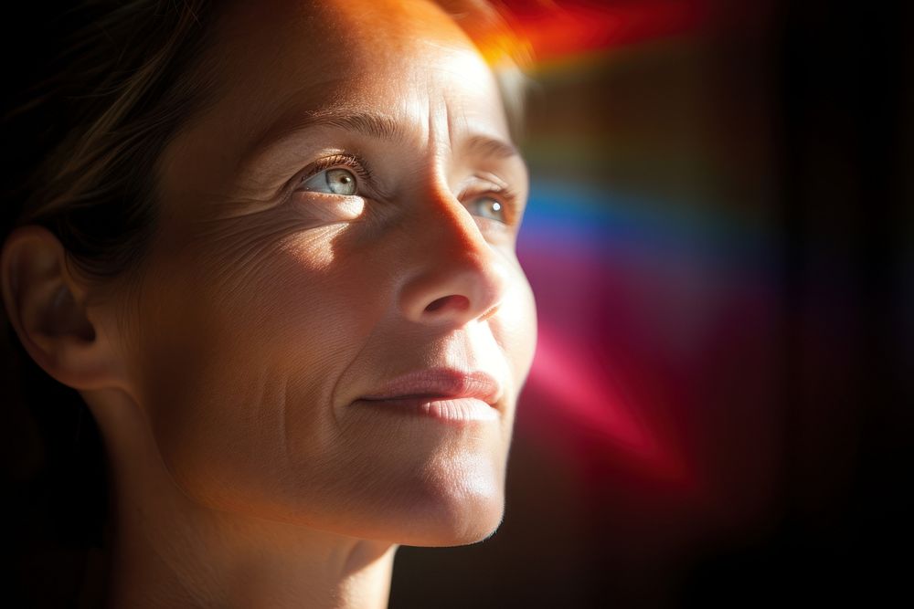 Rainbow light on a middle aged woman face photography portrait adult. AI generated Image by rawpixel.