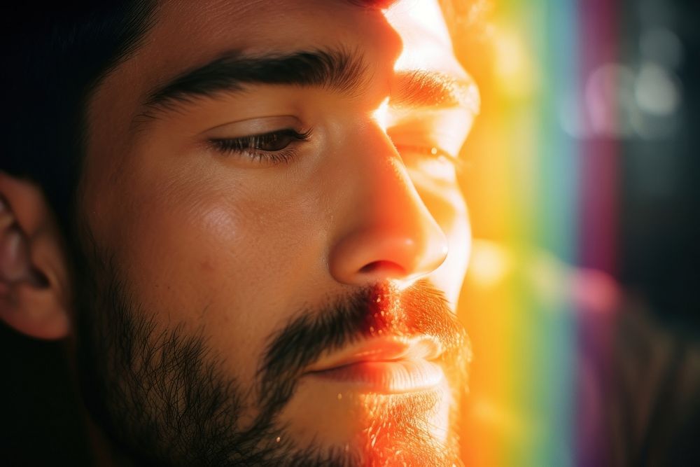 Rainbow light on hispanic man face photography portrait beard. AI generated Image by rawpixel.