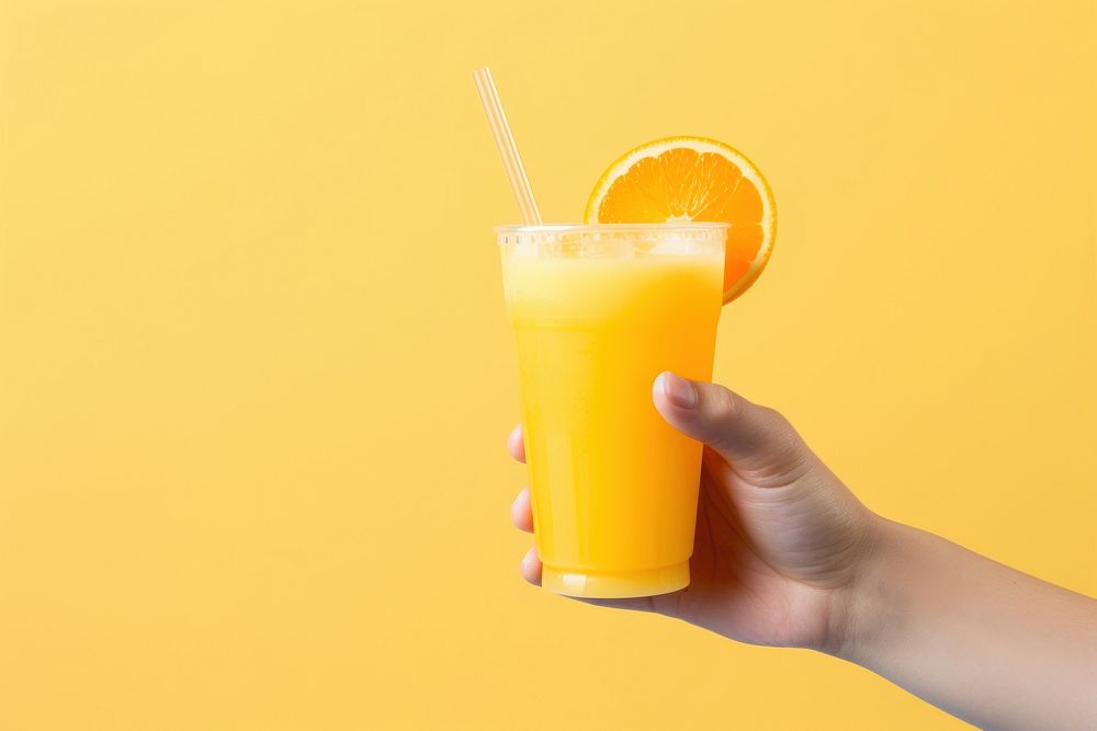 Hand holding orange juice drink fruit food. AI generated Image by rawpixel.