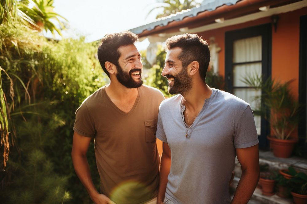 Gay hispanic couple talking together outdoors people adult. AI generated Image by rawpixel.