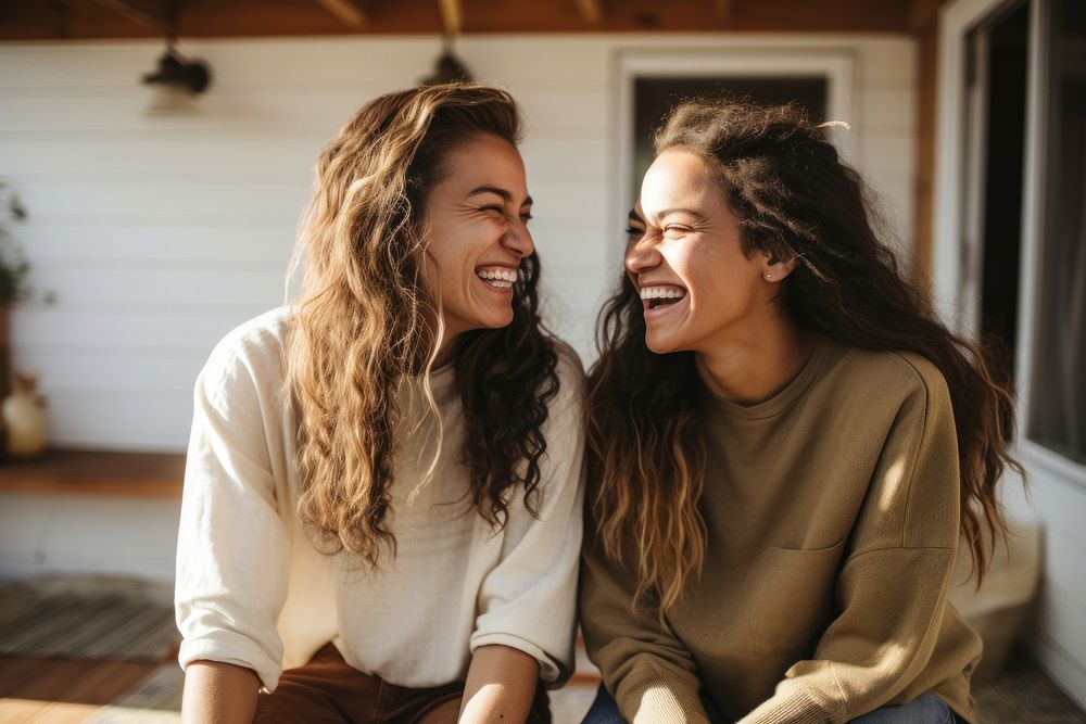 Lesbian hispanic couple talking together laughing outdoors adult. AI generated Image by rawpixel.