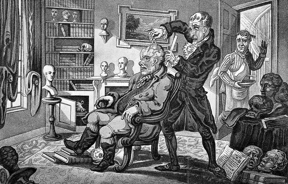 Doctor Spurzheim in his consulting room measuring the head of a peculiar looking patient; a bemused barber looks on.…
