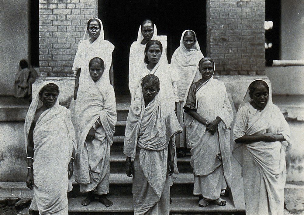 The Albert Victor asylum for lepers, Gohea, Calcutta, India: female patients in white saris on the steps of the female…