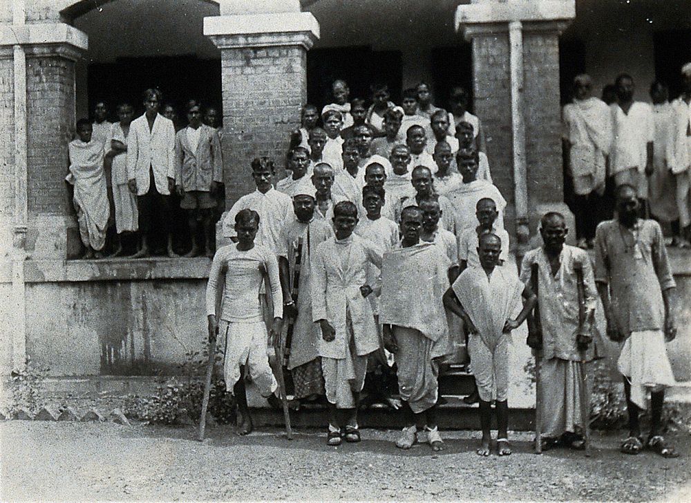 The Albert Victor asylum for lepers, Gohea, Calcutta, India: male patients in white robes on the steps of the male block.…