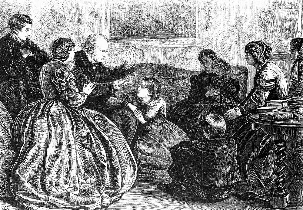 A family group of women and children sitting listening to a man telling a story at Christmas. Wood engraving by Dalziel…