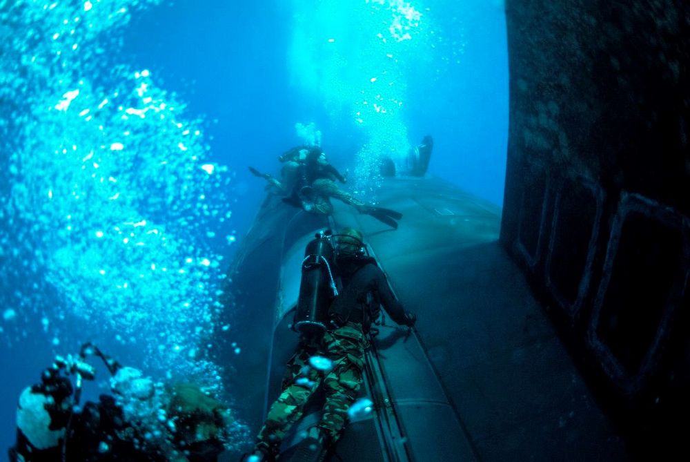 MEDITERRANEAN SEA - U.S. Navy SEALs conduct diving operations alongside the Virginia-class attack submarine USS New Mexico…