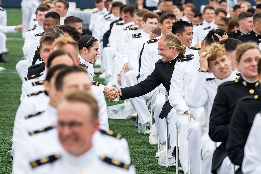 Midshipmen congratulate one another during the U.S. Naval Academy commencement, Friday, May 27, 2022, at the Navy-Marine…