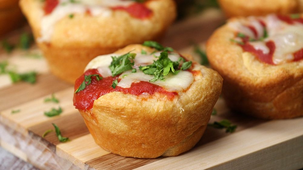 Close up of pizza popovers on a cutting board.