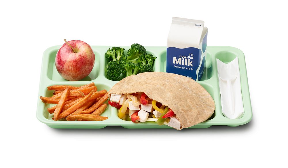 A school lunch tray showing a reimbursable meal for grades 9 through 12 served by Hilton Central Schools in New York. Also…