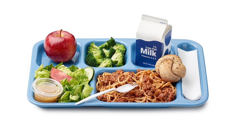 A school lunch tray showing a reimbursable meal for grades 9 through 12 served by Mesa Public Schools in Arizona. Also shows…