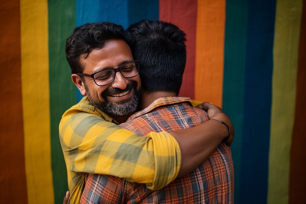 South asian man hugging adult affectionate togetherness. AI generated Image by rawpixel.