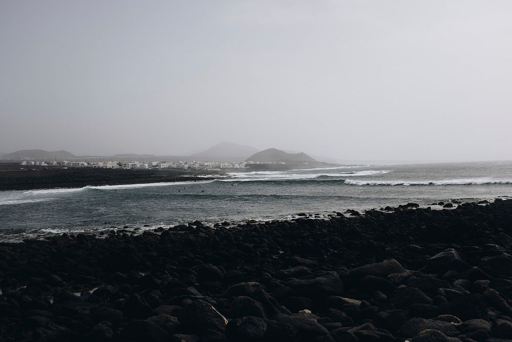 Foggy, misty sea, black pebbles, free public domain CC0 photo.