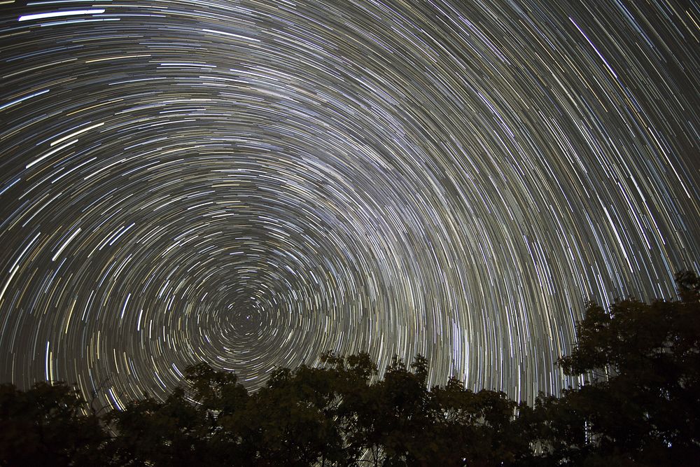 Free spinning star trails photo, public domain sky CC0 image.
