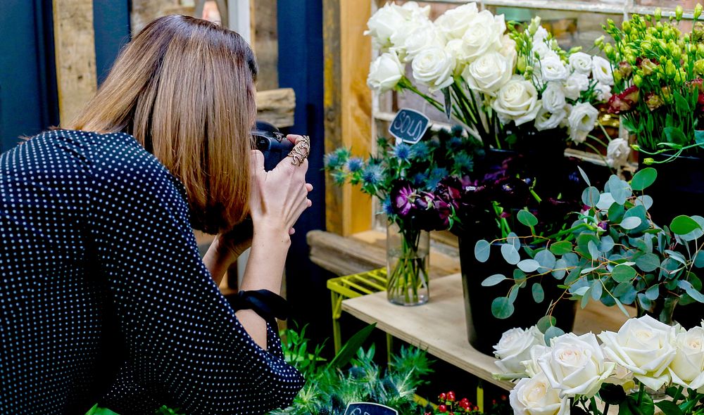 Free female photographer in flower shop image, public domain photography CC0 photo.