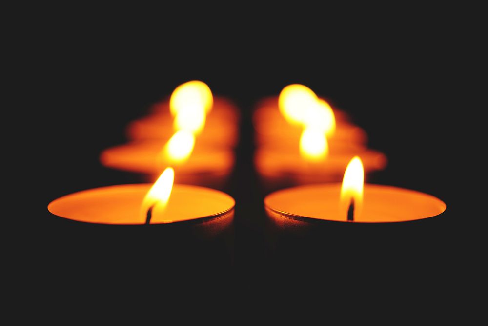 Free candle lights fire in dark background photo, public domain CC0 image.
