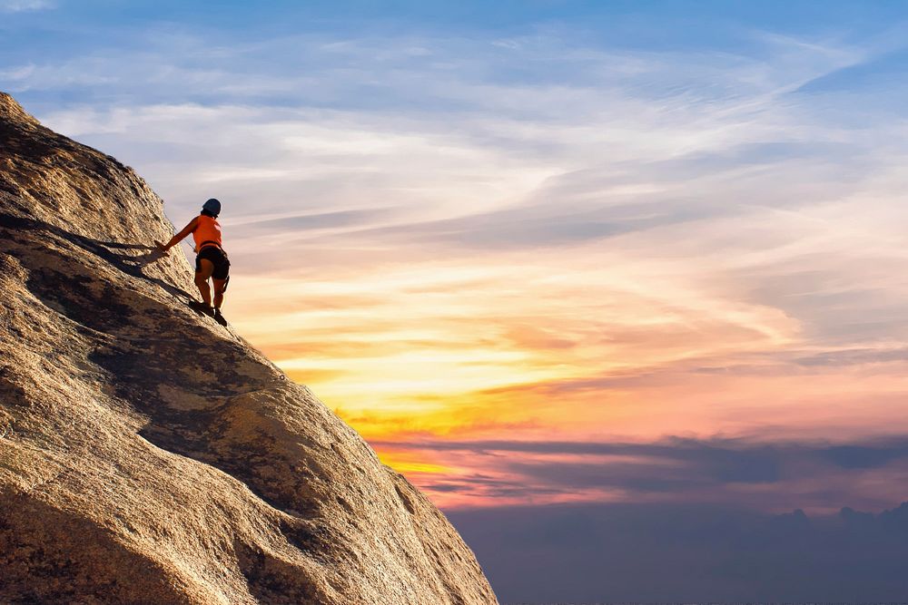 Free person climbing rock during sunset photo, public domain sport CC0 image.