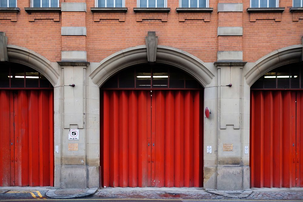 Free bright red garage doors of a fire hall in the city image, public domain city of London CC0 photo.