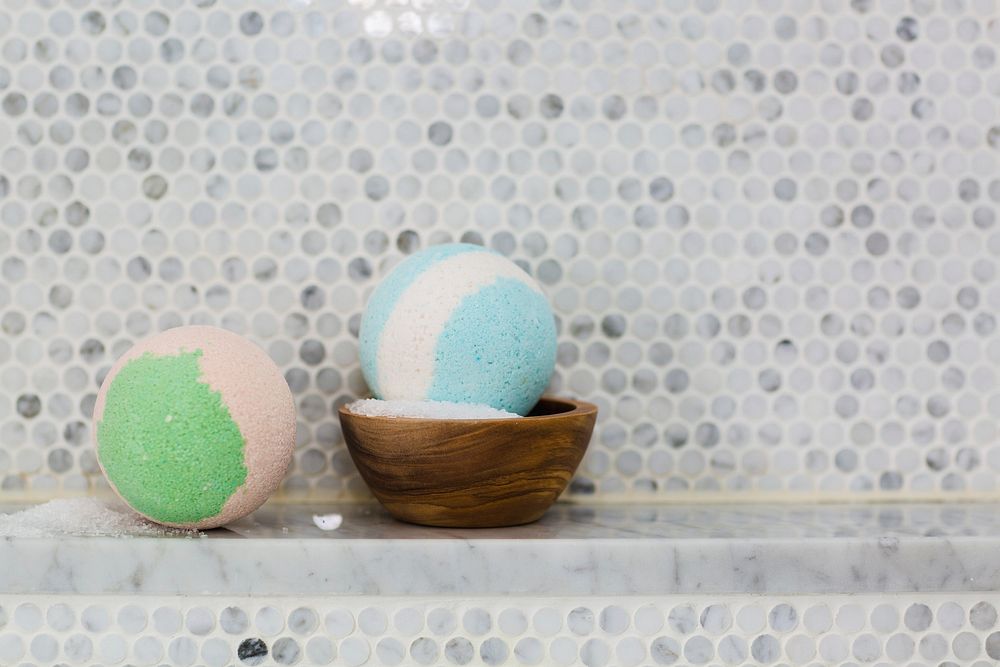 Free two bath bombs and wooden bowl of Epsom salt in spa bathroom photo, public domain CC0 image.
