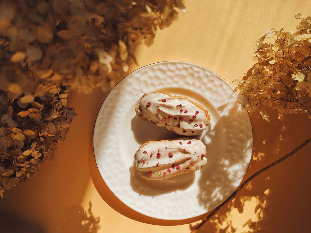 Free delightful eclairs with white glaze and raspberry crumb image, public domain food CC0 photo.