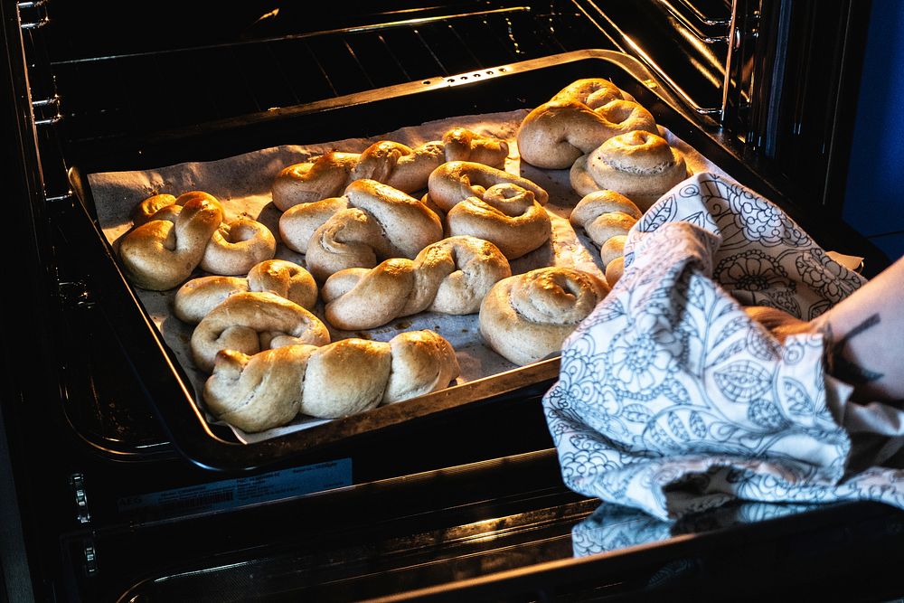 Free woman taking out homemade baked dessert from oven image, public domain food CC0 photo.