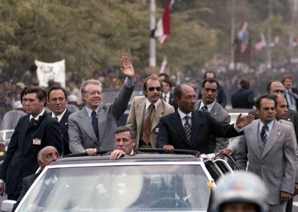 Carter and Sadat ride in a motorcade through Cairo, March 8, 1979 (Photo courtesy of Jimmy Carter Library). Original public…