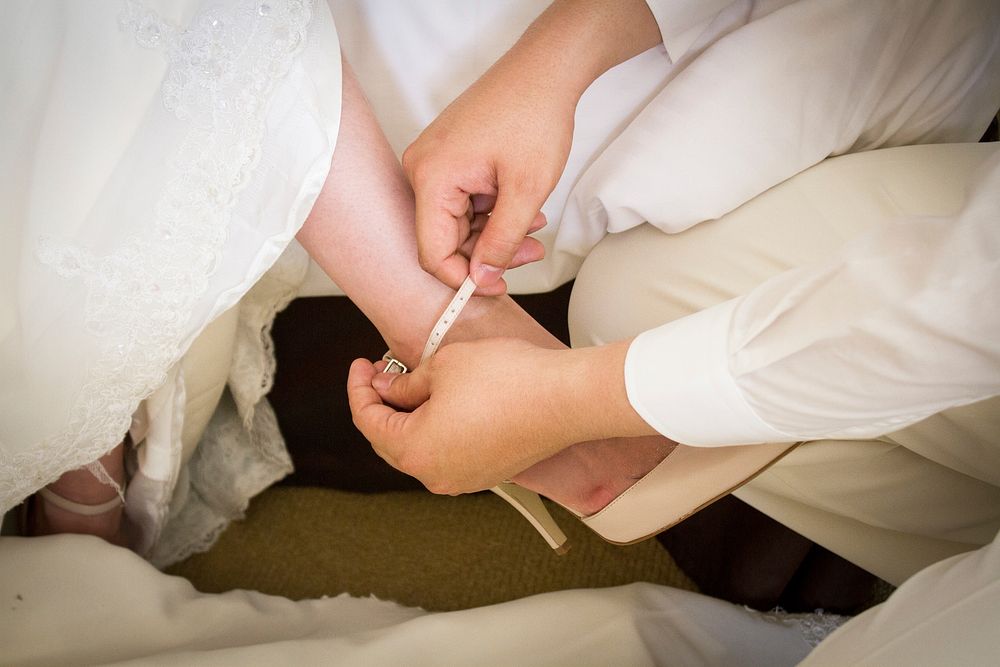 Bride putting on shoes. Free public domain CC0 photo.