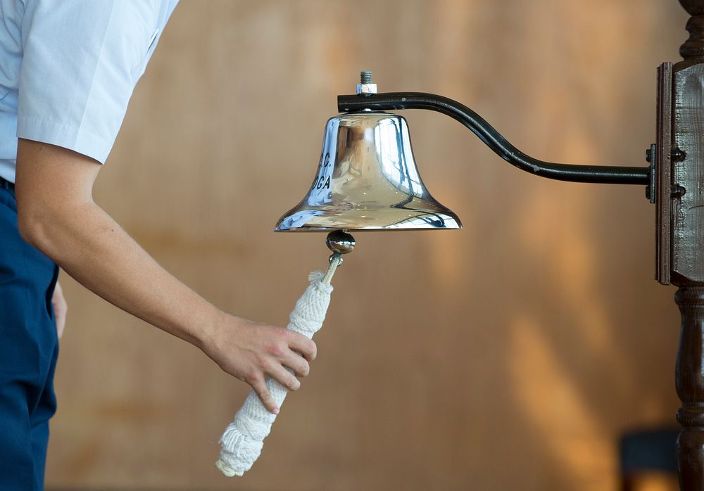 A person ringing ship's bell.Original public domain image from Flickr