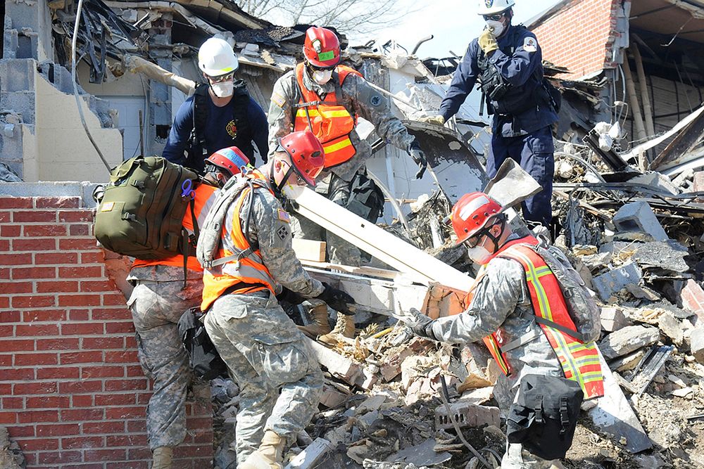 U.S. Army Soldiers from Georgia National Guard&rsquo;s 810th Engineer Company remove debris from a partially-collapsed…