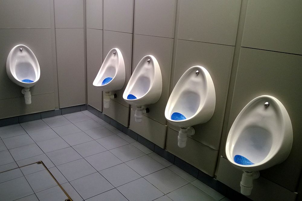 Row of male urinals in public toilet. Original public domain image from Flickr