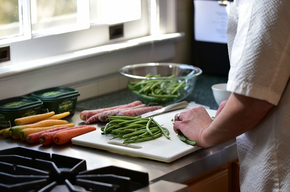 Chef preparing vegetables dishes in the kitchen. Original public domain image from Flickr