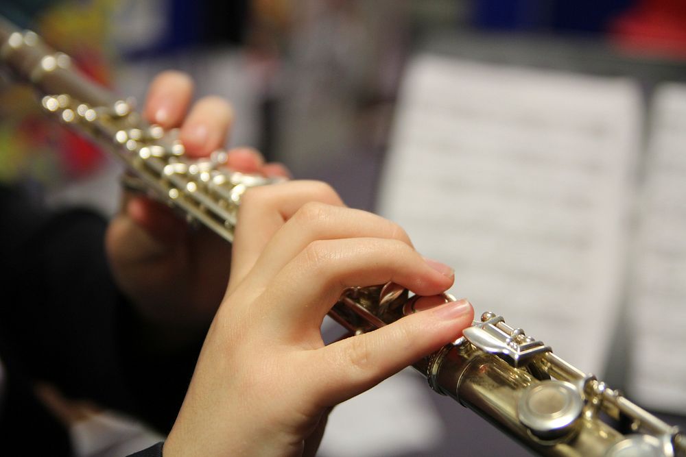 Musician playing a flute. Original public domain image from Flickr