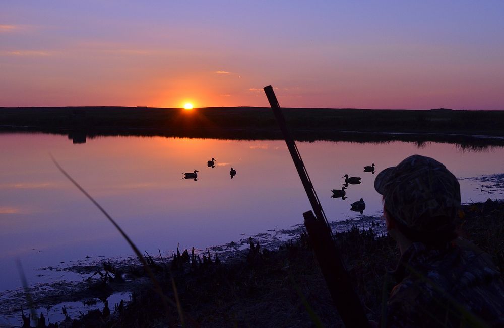 Waterfowl hunting at sunset (Photo by Chuck Traxler/USFWS). Original public domain image from Flickr