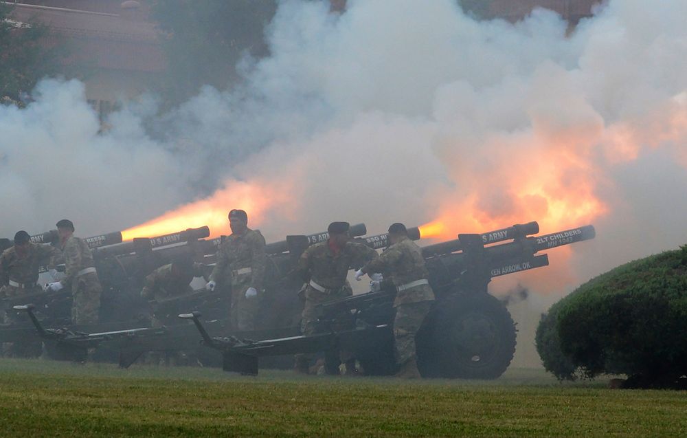 Bravo Battery, 2nd Battalion, 2nd Field Artillery "Salute Battery" fires cannons during the 77th Army Band's rendition of…