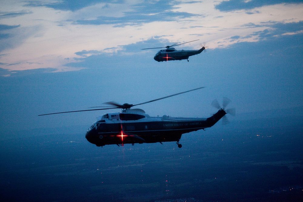 Support helicopters fly at dusk with Marine One en route to the South Lawn of the White House from Camp David, May 24, 2009.