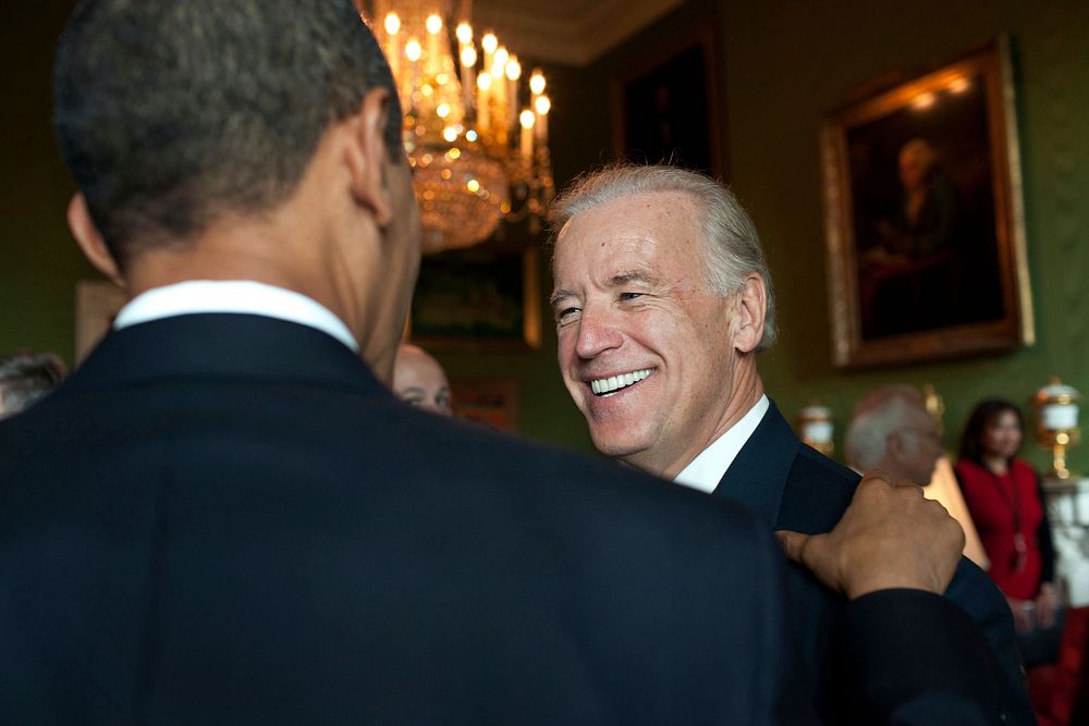 President Barack Obama talks with Vice President Joe Biden in the Green Room of the White House prior to the signing…