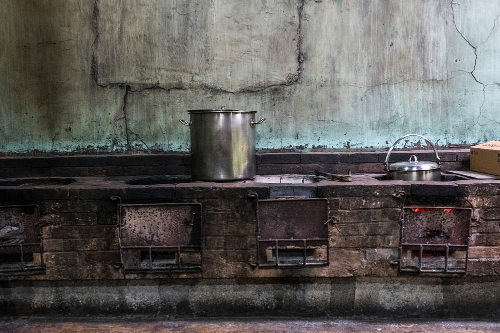 Food preparation in an old kitchen. Free public domain CC0 photo.