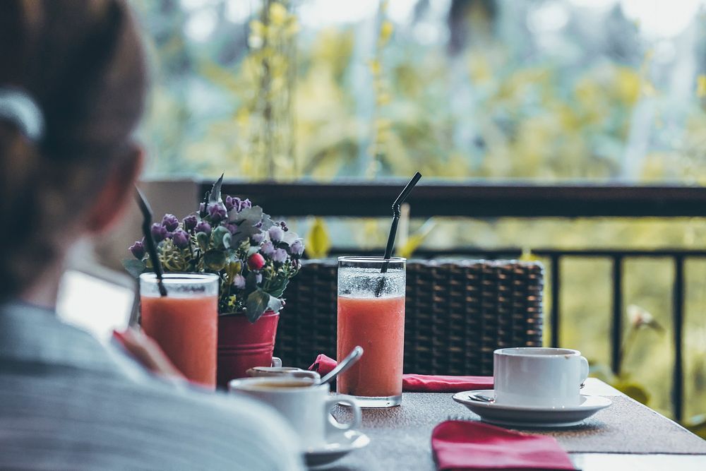 Woman having breakfast at hotel. Free public domain CC0 photo.