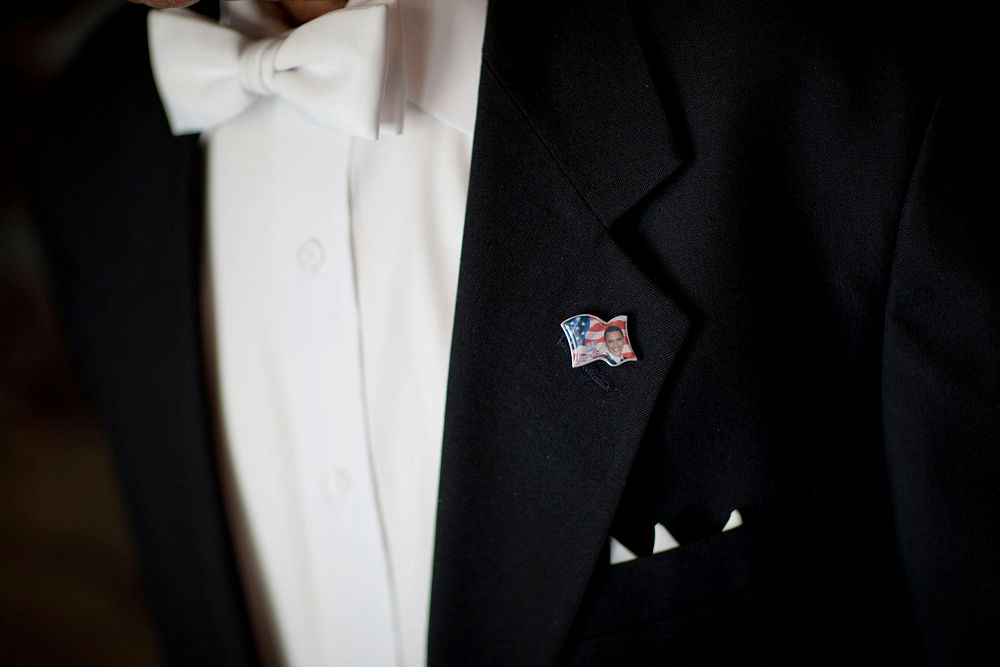 A pin with President Barack Obama's picture is displayed on the lapel of White House Doorman Wilson Roosevelt Jerman, Dec.…