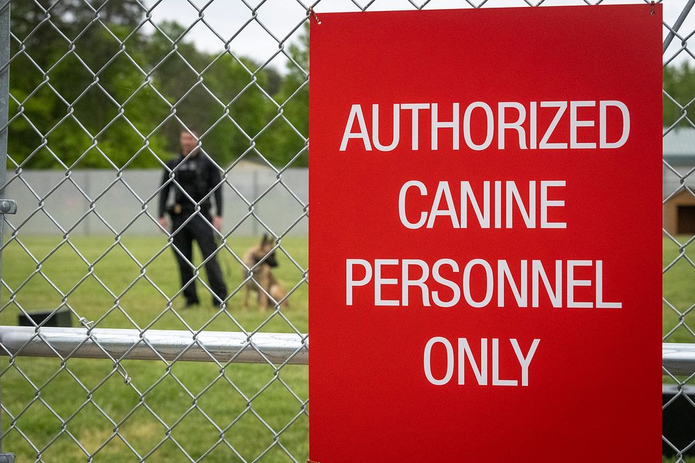 Officer at a training facility for United States Secret Service along with a police dog. Original public domain image from…