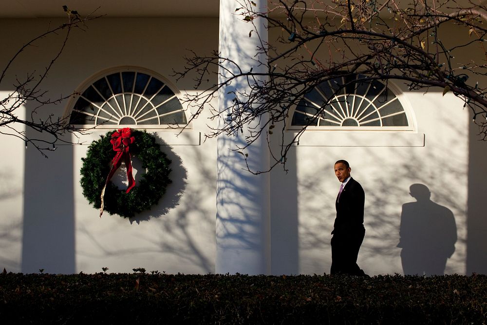 President Barack Obama whistles as he walks along the Colonnade of the White House following a holiday reception, Dec. 14…