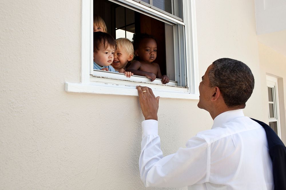 President Barack Obama greets children at a day care facility adjacent to daughter Sasha's school in Bethesda, Md.…