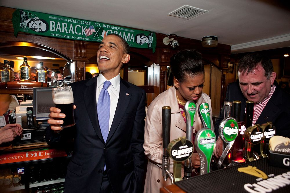 President Barack Obama talks with pub-goers as First Lady Michelle Obama draws a pint at Ollie Hayes pub in Moneygall…