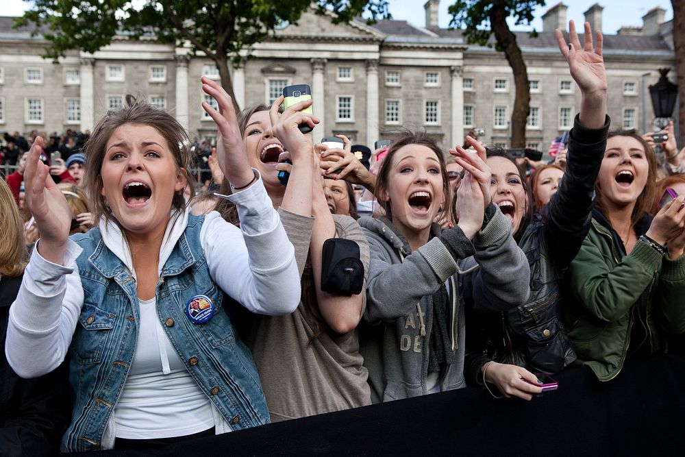 People cheer as President Barack Obama and First Lady Michelle Obama are introduced during an Irish celebration at College…