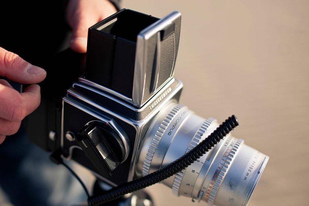 Photographer with analog camera. Free public domain CC0 image.