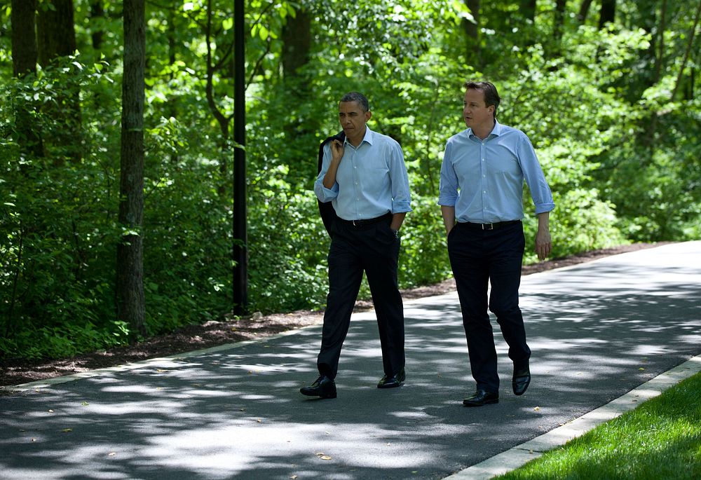 President Barack Obama and Prime Minister David Cameron of the United Kingdom talk as they walk to Laurel Cabin during the…