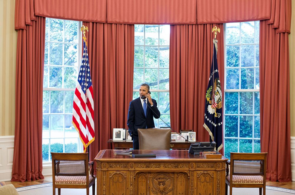 President Barack Obama talks on the phone with Solicitor General Donald Verrilli in the Oval Office, after learning of the…